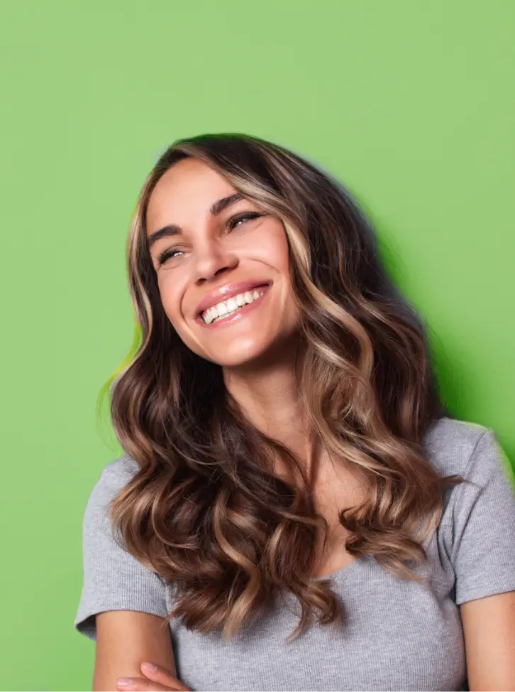 Smiling woman over a green backdrop